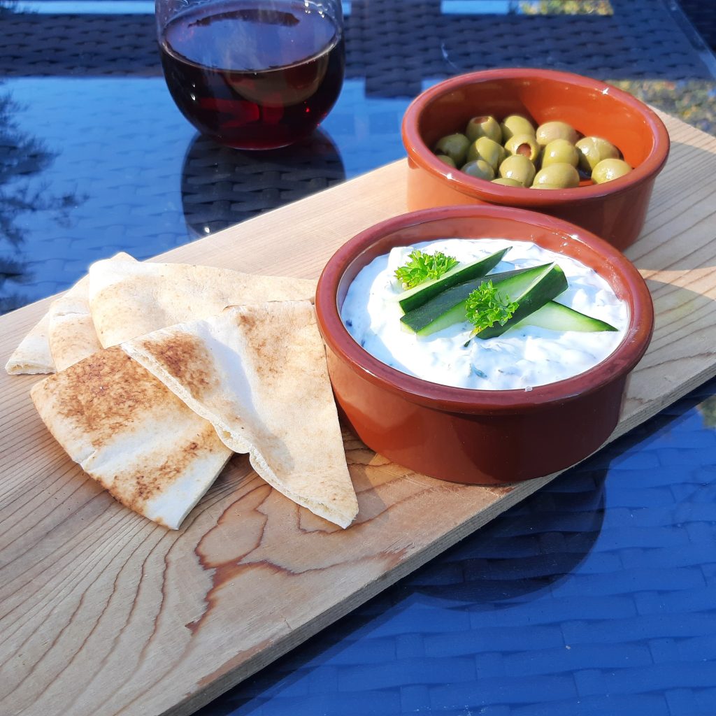 Tzatziki with a side of pita and olives