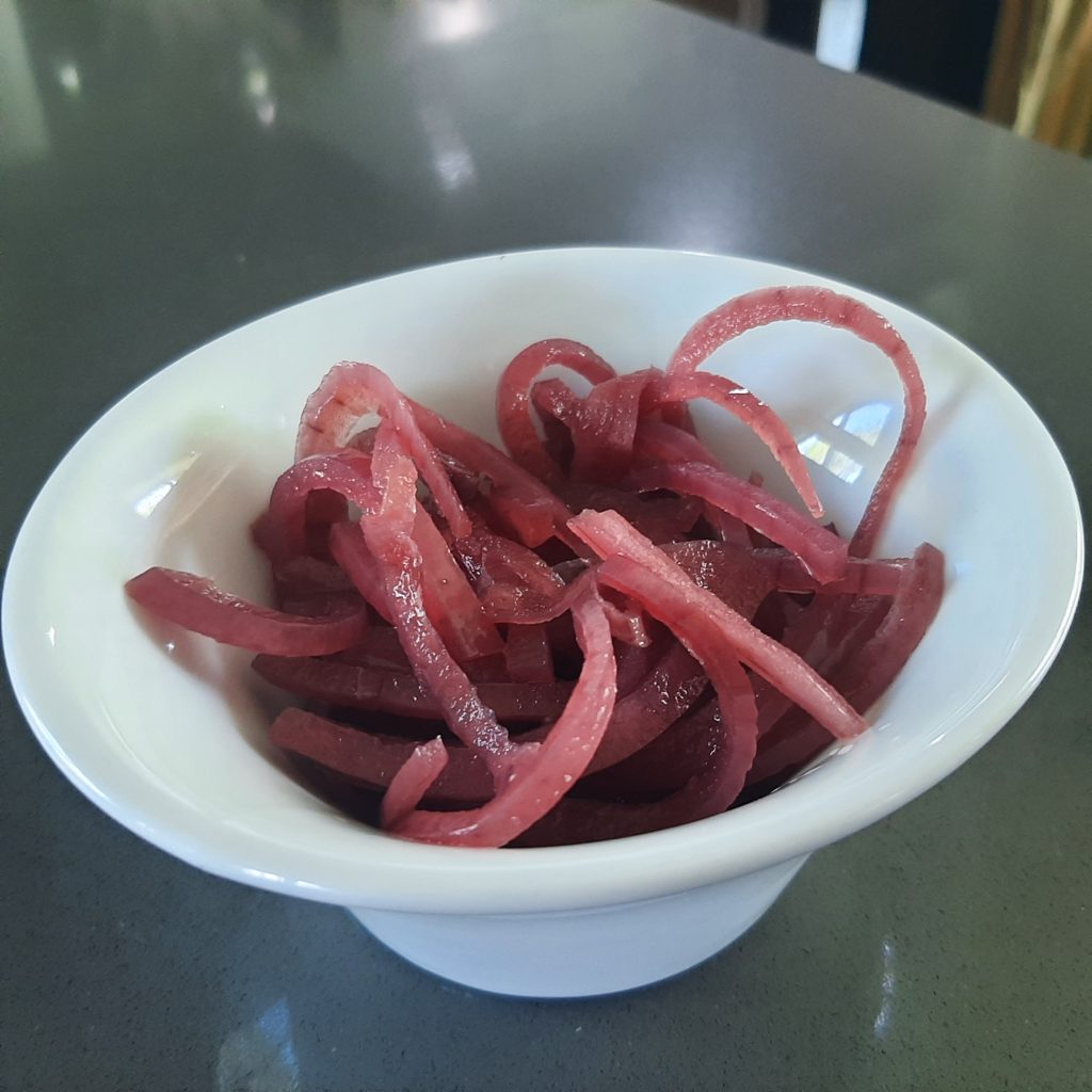 A bowl of pickled red onions