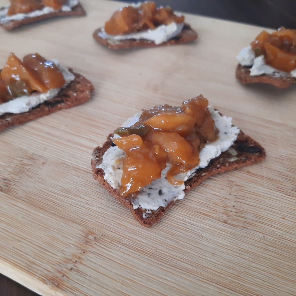 Hot pepper peach spread on a cracker with creamcheese